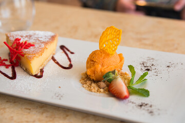 Delicius dessert for sharing. Cheese cake and orange ice cream