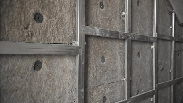 Installation of thermal insulation on the wall of the house