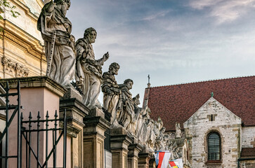 Fototapeta premium Krakow, Poland - November 12, 2022: Beautiful gothic facade and statues of the catholic Church of the Holy Apostles Peter and Paul in the historical district of Krakow