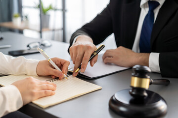 Lawyer colleagues or legal team working or drafting legal document at law firm office desk. Gavel...