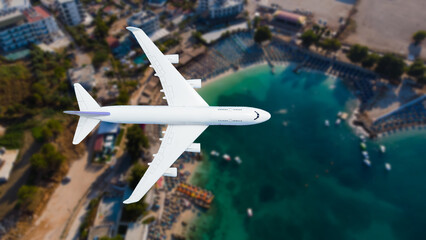 Fototapeta premium Airplane flying over beach with palm tree, white sand and turquoise ocean
