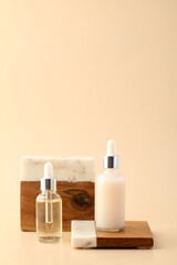 Serum and essential oil on dropper bottles on podiums. Natural organic beauty products design.