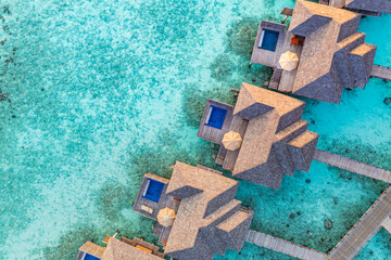 Aerial sunset landscape, luxury tropical resort water villas. Beautiful island beach, palm trees,...