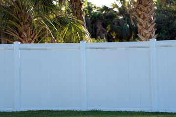 White plastic fence for back yard protection and privacy