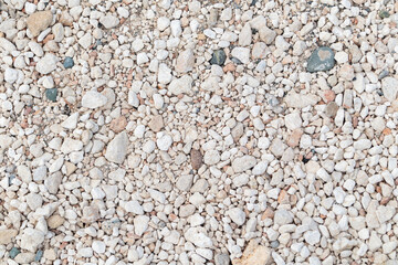 A background of stones. Texture of light stones, evenly lit background of stones