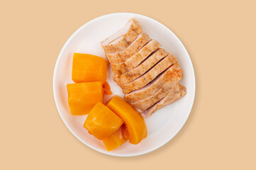  Turkey fillet with pumpkin cooked in sous vide in a plate on an orange background. healthy diet...