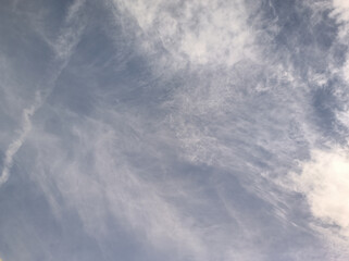 The blue sky turns white. White clouds try to merge with the sky