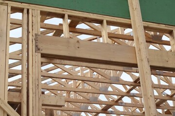 Low angle shot of wooden structure of an unfinished new house