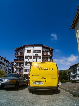 Yellow car with the logo Spanish national Correos post company.