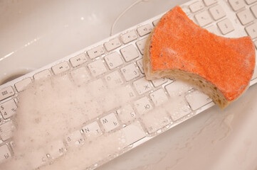 White computer keyboard with sponge in foam. 