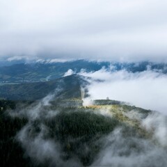 Drone shot of fog over mountains