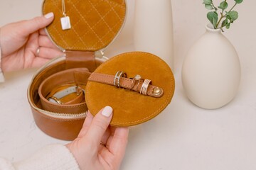 Closeup of female hands holding jewelry box and ring keeper
