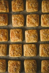 Vertical top-view of homemade sesame scones placed on a flat surface