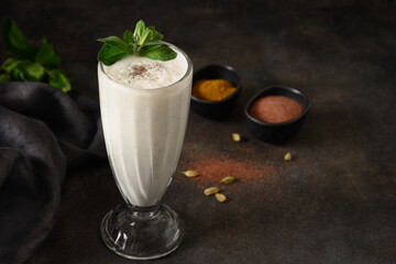 Indian Salty lassi with mint leaves and kala namak on black background. Traditional freshness lassi...