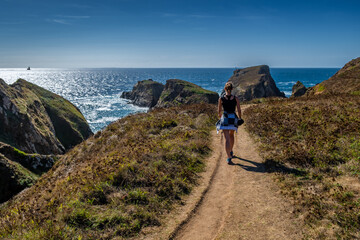 Young Woman On Coastal Hiking Path With Spectacular Cliffs At Peninsula Pointe Du Van On Cap Sizun...