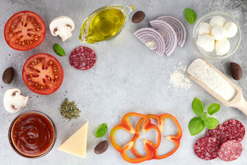 Ingredients for cooking pizza: mozzarella, onion, tomato, flour, mushrooms, salami, spices, olives on a gray background. Top view. Copy Space.