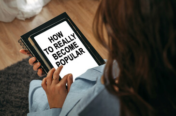 A woman holds a tablet in her hands on the screen of which it is written - How To Really Become Popular