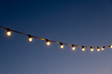 light bulbs garlands against sky - Powered by Adobe