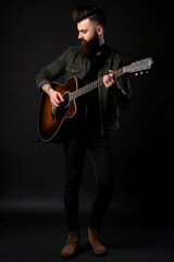 Handsome young man with long beard playing guitar on black background. Generative AI