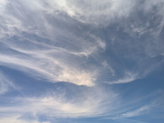 Abstract spiral clouds merging with the sky