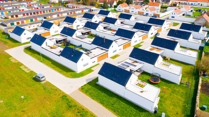 Suburban district houses from above. Passive buildings full of modern technologies for...
