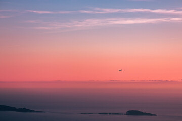 Fototapeta na wymiar Plane flying during the sunset