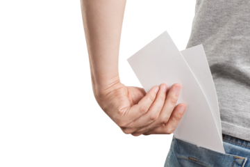 Male hand holding two blank sheets of paper (tickets, flyers, invitations, coupons, banknotes, etc.), cut out