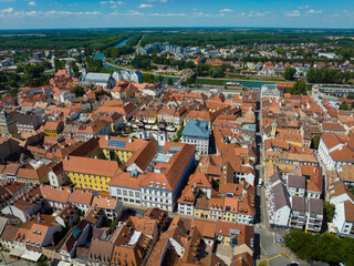 Fototapeta na wymiar Aerial shot of Gyor city center, Hungary. Central square, houses with tiled roofs and the river in Gyor
