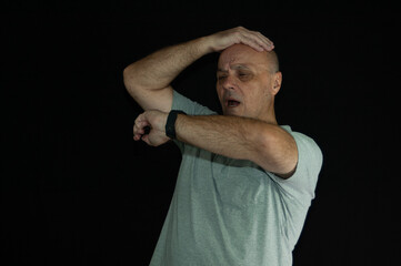 old man worried late on black background