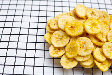 Banana slice chips on white background.