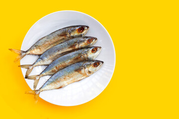 Salted fish on yellow background.