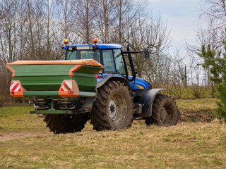 Spring, the beginning of sowing. A seeder attached to a tractor.