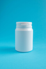 Pharmaceutical container on blue background.