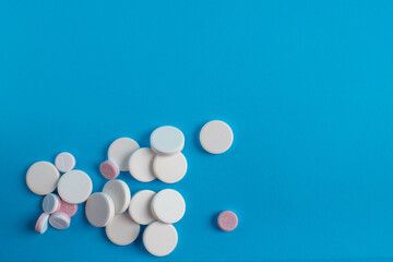 many medicinal tablets on a blue background