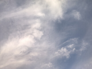 White clouds being illuminated at sunset
