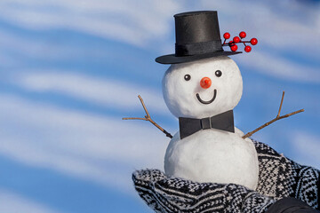 View of a little snowman with a top hat. Holiday christmas background with copy space for text