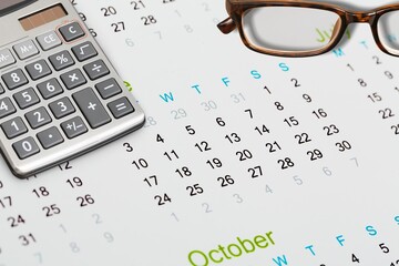2023 tax concept, calendar, calculator and glasses.