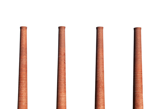 Four old brick factory smokestacks isolated with cut out sky.