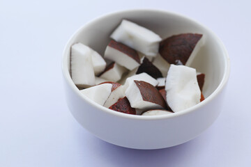slice of fresh coconut on a table cloth 