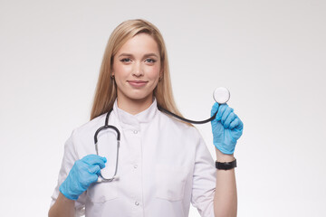 Confident female doctor posing in her office and smiling at camera, health care and prevention concept