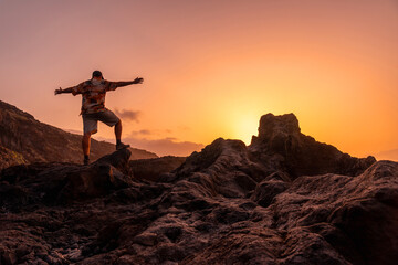 El Hierro Island. Canary Islands, a man enjoying holidays in Charco Azul at sunset, freedom by the sea