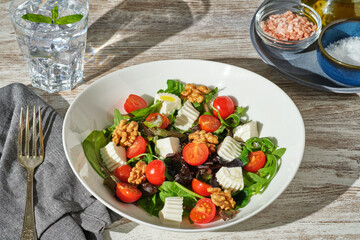45 degree shot of a plate of healthy fresh salad on top of a table
