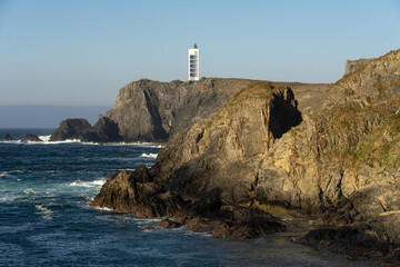 Punta Frouxeira lighthouse with the cliffs in the Rias Altas touristic area of Galicia at sunset, Valdoviño, Meiras, Spain.