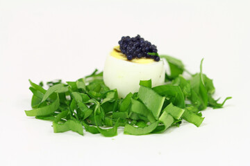 Quail egg with wild garlic and caviar substitute.