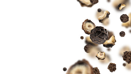 Close-up organic peppercorn, whole and sliced, flying on white background for recipes. Floating dried black pepper. Spicy additive ingredient. Creative spices modern food concept. Copy space for text