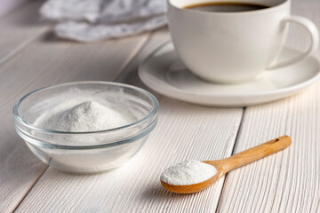Herbal sweetener stevia in spoon and a cup of coffee