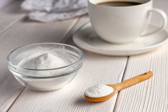 Herbal sweetener stevia in spoon and a cup of coffee