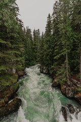 Green water rushing through a rock canyon