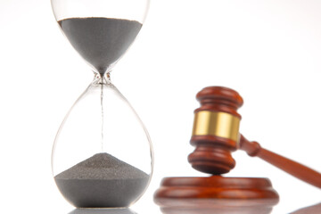 gavel of justice on the background of an hourglass. The time of the verdict and the term of the...