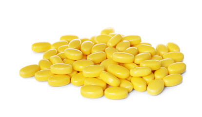 Tasty yellow dragee candies on white background
